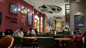 People sitting in a cozy coffee shop interior.